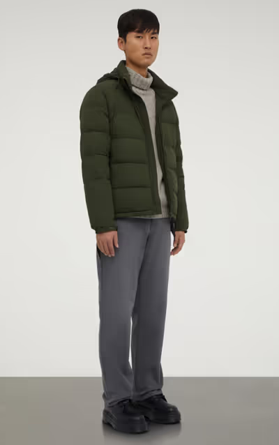 A man wearing a ASPESI green nylon quilted jacket