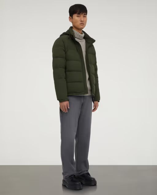 A man wearing a ASPESI green nylon quilted jacket