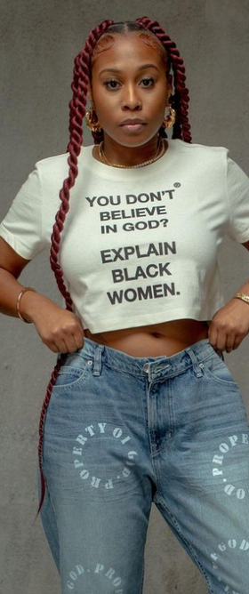 A woman wearing a God Is Dope crop top white t-shirt