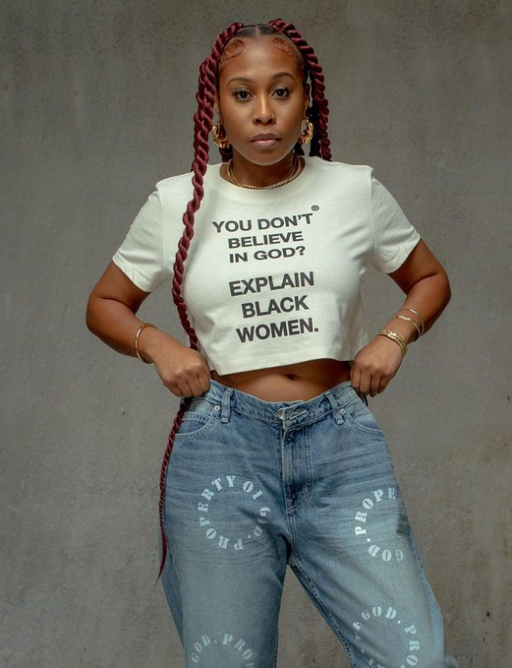 A woman wearing a God Is Dope crop top white t-shirt