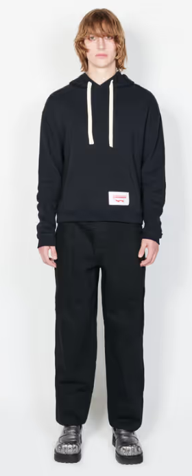 A man wearing a Charles Jeffrey LOVERBOY black ears hoody