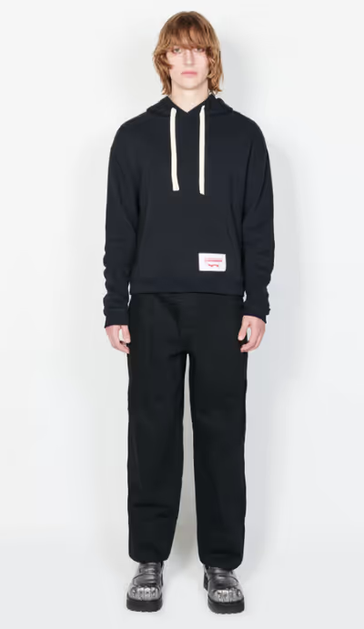 A man wearing a Charles Jeffrey LOVERBOY black ears hoody