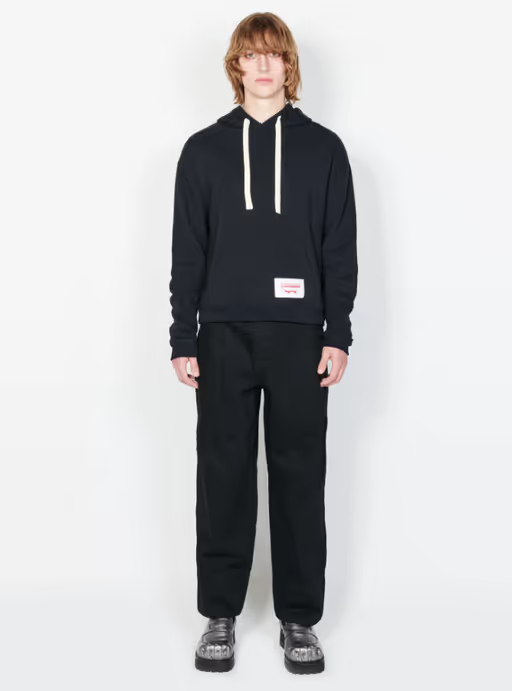 A man wearing a Charles Jeffrey LOVERBOY black ears hoody