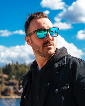 A man wearing a blue-tinted Shady Rays sunglasses