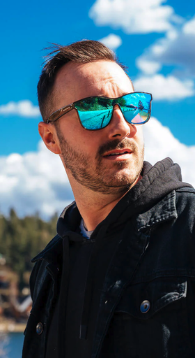 A man wearing a blue-tinted Shady Rays sunglasses