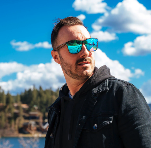 A man wearing a blue-tinted Shady Rays sunglasses