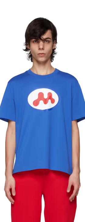A man wearing a Mowalola blue t-shirt