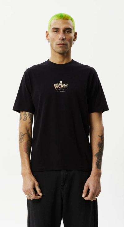 A man wearing a Afends retro fit black t-shirt