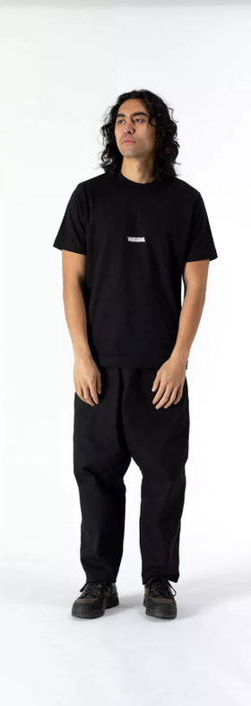 A man wearing a WAWWA basic logo heavyweight organic black t-shirt