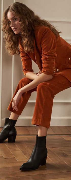 A woman wearing a pair of Gianvito Rossi black boot