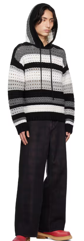 A man wearing a Nahmias black & white striped hoodie