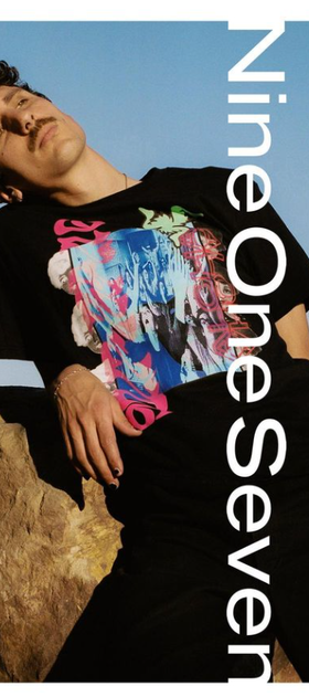 A man wearing a Nine One Seven aloha black t-shirt