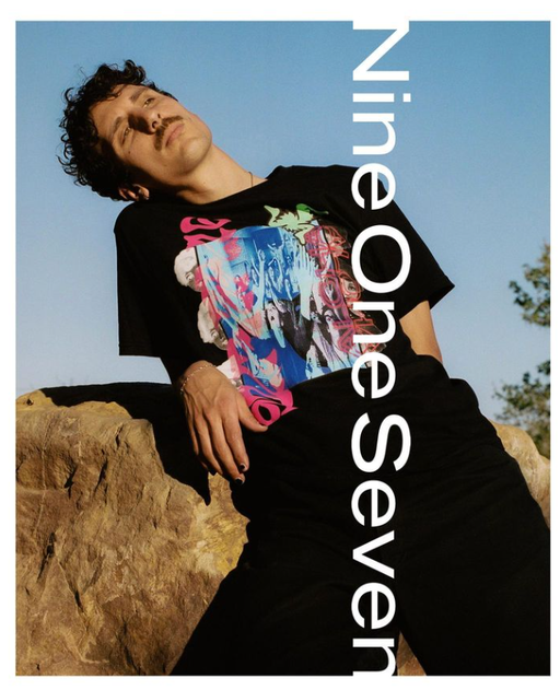 A man wearing a Nine One Seven aloha black t-shirt