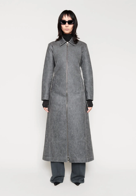 A woman wearing a CHIMI Glasses grey long coat