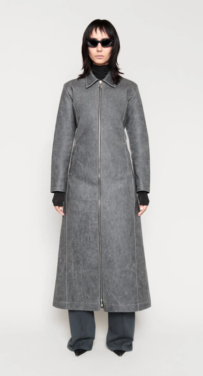 A woman wearing a CHIMI Glasses grey long coat