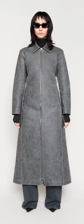 A woman wearing a CHIMI Glasses grey long coat