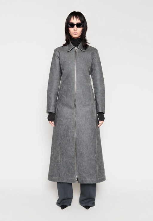 A woman wearing a CHIMI Glasses grey long coat