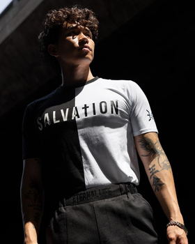 A man wearing a 3:16 Collection black and white t-shirt