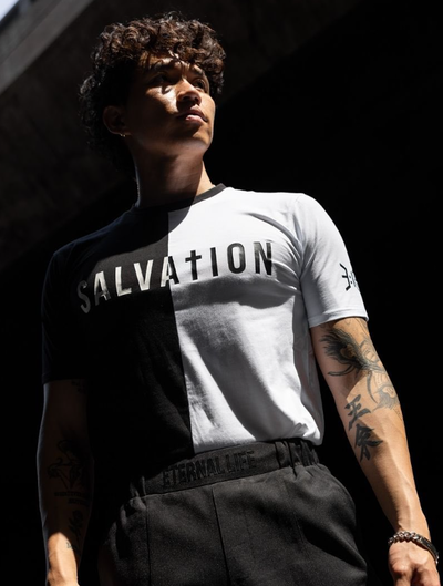 A man wearing a 3:16 Collection black and white t-shirt