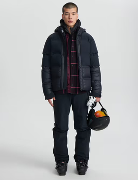A man wearing a Aztech Mountain space black ski jackets