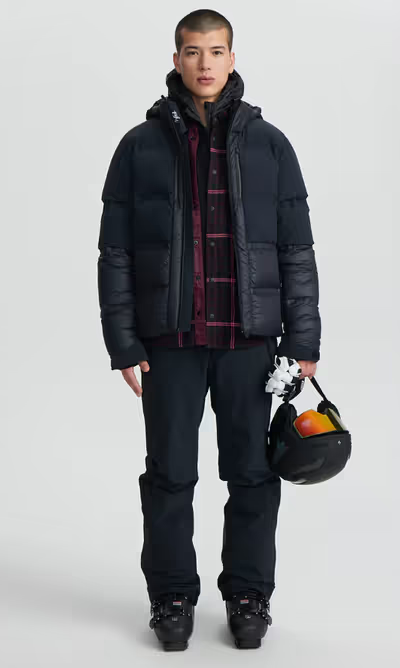 A man wearing a Aztech Mountain space black ski jackets
