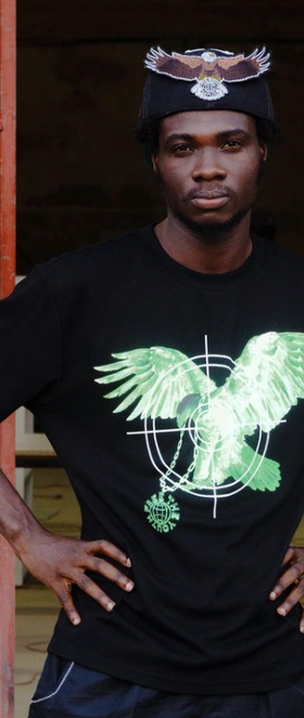 A man wearing a Free the Youth black t-shirt