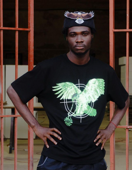 A man wearing a Free the Youth black t-shirt