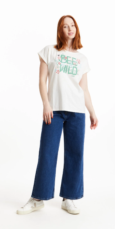 A woman wearing a People Tree bee wild print tee in eco white