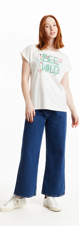 A woman wearing a People Tree bee wild print tee in eco white