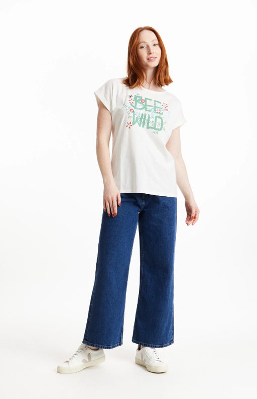 A woman wearing a People Tree bee wild print tee in eco white