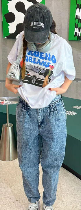 A woman wearing a Catori Clothing trueno dream white t-shirt