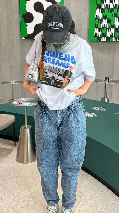 A woman wearing a Catori Clothing trueno dream white t-shirt