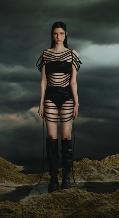 A woman wearing a YUME YUME black strappy dress