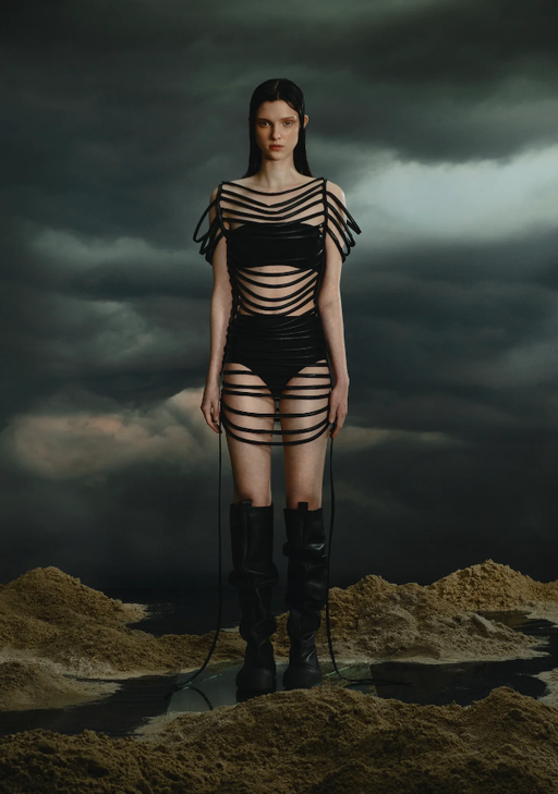A woman wearing a YUME YUME black strappy dress
