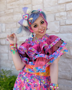 A woman wearing a 6%DOKIDOKI babydoll dress