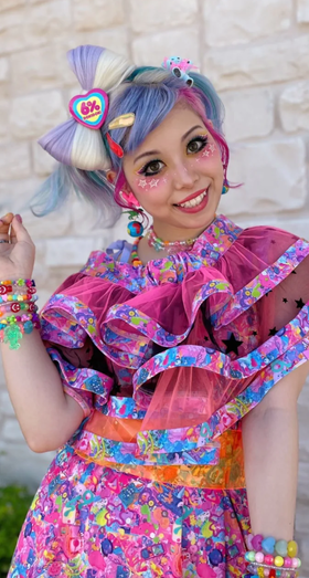 A woman wearing a 6%DOKIDOKI babydoll dress