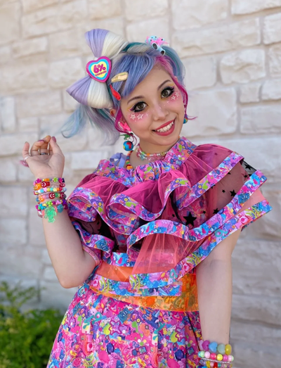 A woman wearing a 6%DOKIDOKI babydoll dress