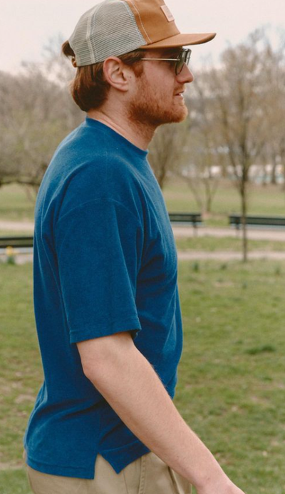 A man wearing a Battenwear navy t-shirt