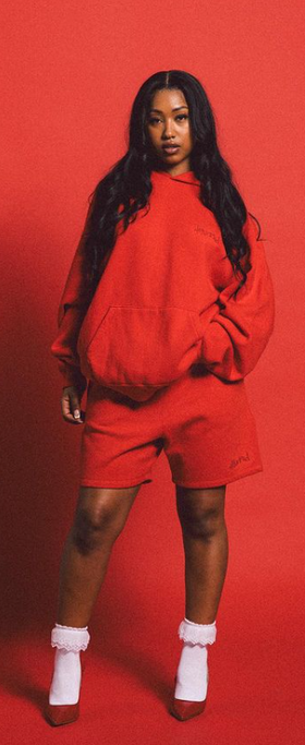 A woman wearing a 4Hunnid red hoodie