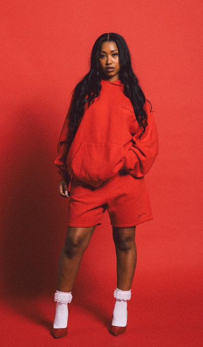 A woman wearing a 4Hunnid red hoodie