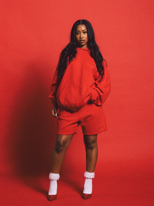 A woman wearing a 4Hunnid red hoodie
