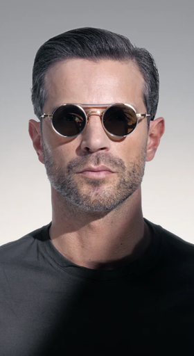 A man wearing a Akoni Eyewear brushed white gold designer sunglasses