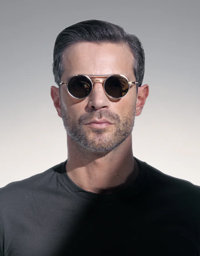 A man wearing a Akoni Eyewear brushed white gold designer sunglasses