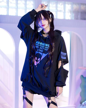 A woman wearing a Harajuku Hearts alien separate sleeve belt black hoodie