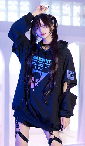 A woman wearing a Harajuku Hearts alien separate sleeve belt black hoodie