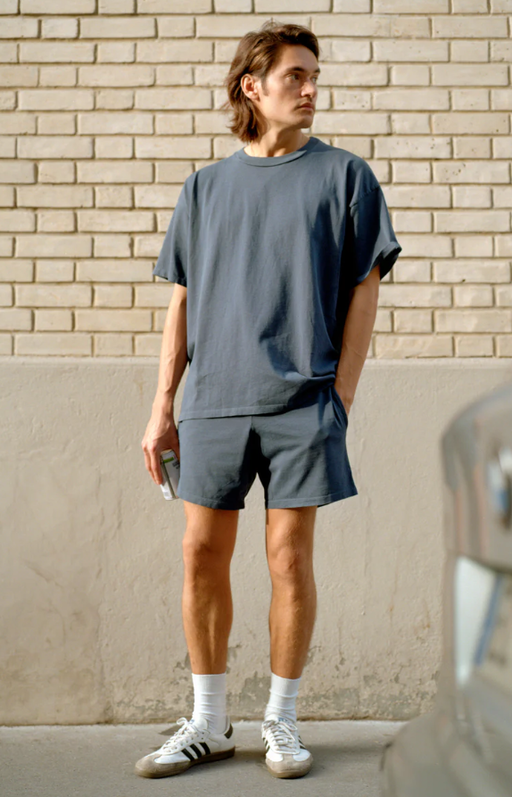 A man wearing a Gil Rodriguez washed navy dimi t-shirt