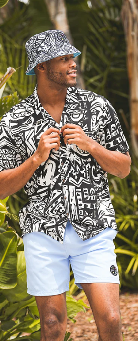 A man wearing a Maui and Sons block party button up shirt