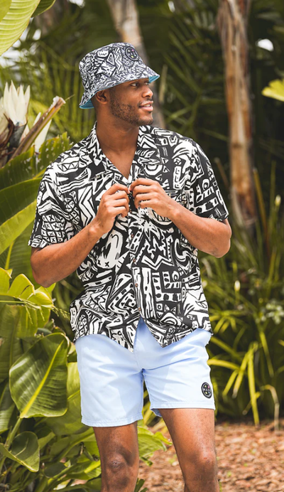 A man wearing a Maui and Sons block party button up shirt