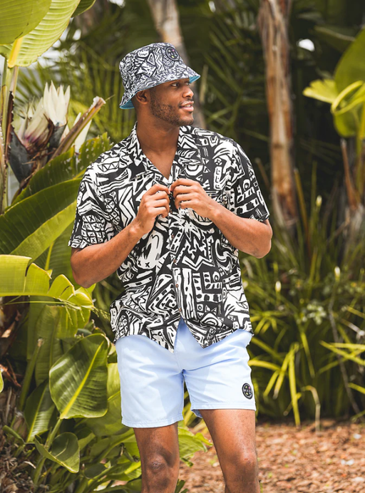 A man wearing a Maui and Sons block party button up shirt