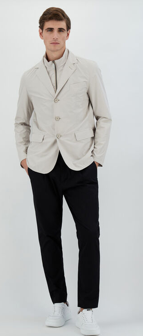 A man wearing a Herno chantilly color blazer